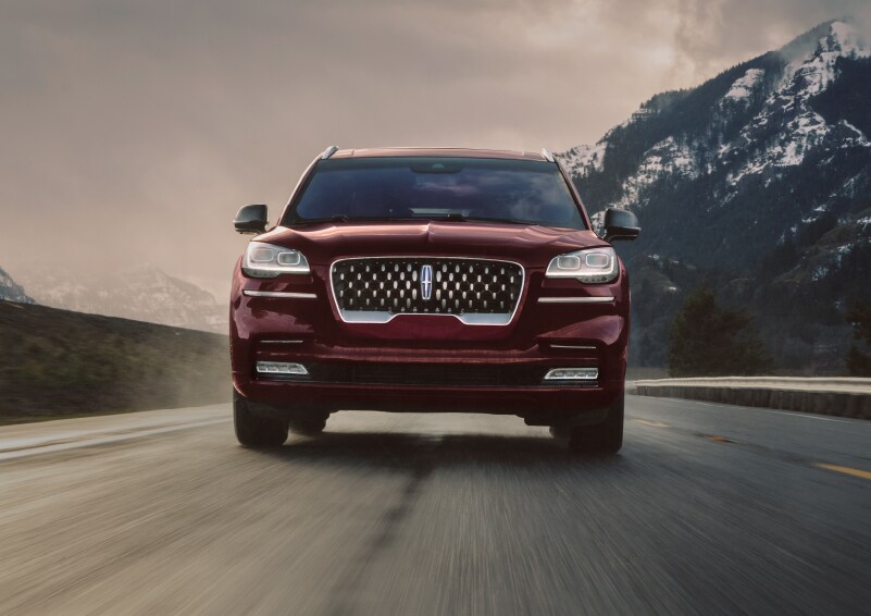 A 2021 Lincoln Aviator Grand Touring is shown being driven in a river valley