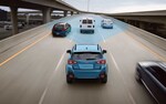 A 2021 Crosstrek Hybrid driving on a freeway with the EyeSight® Driver Assist Technology sensors illustrated with blue overlay.