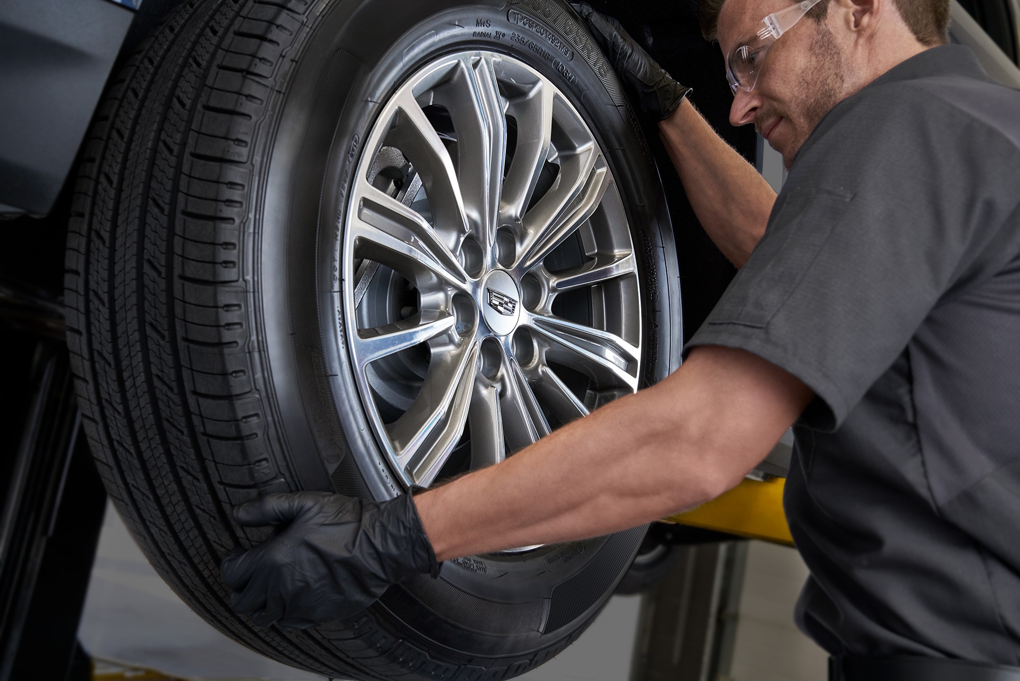 Service Technician Mounting a Tire on a Car
