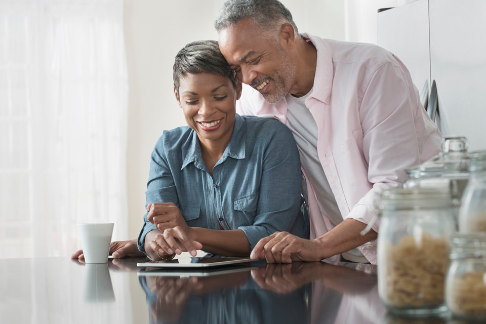Two people reviewing information on a tablet