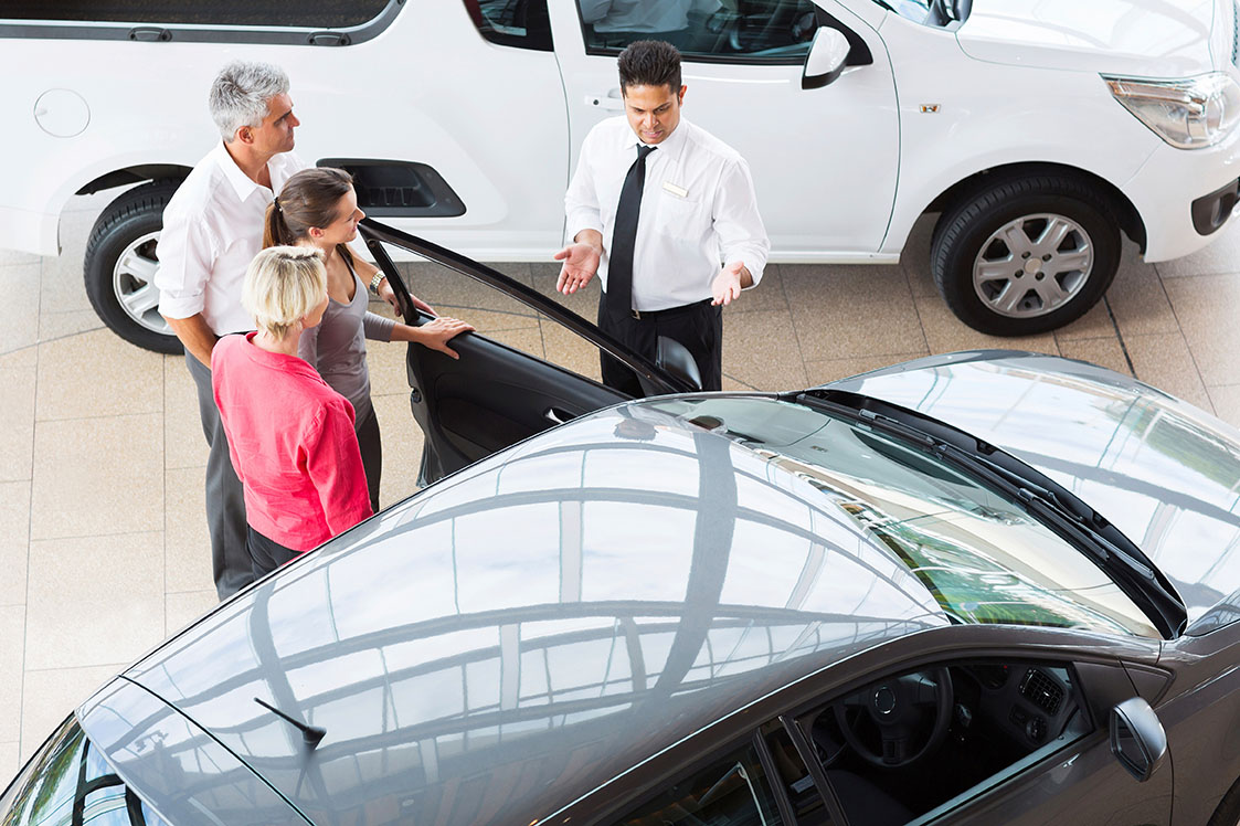 Friendly dealership staff assisting customer