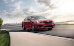 A 2021 Subaru Legacy driving on a country road.