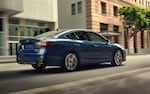A 2021 Subaru Legacy Touring XT driving on a city street.