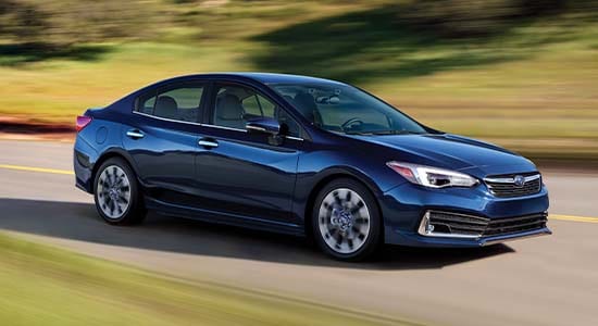 The 2022 Subaru Impreza driving on a road