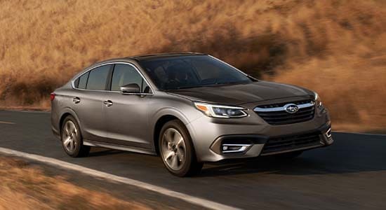 The 2022 Subaru Legacy driving on a road