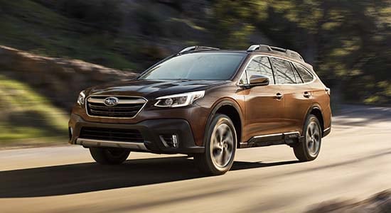 The 2022 Subaru Outback driving on a road