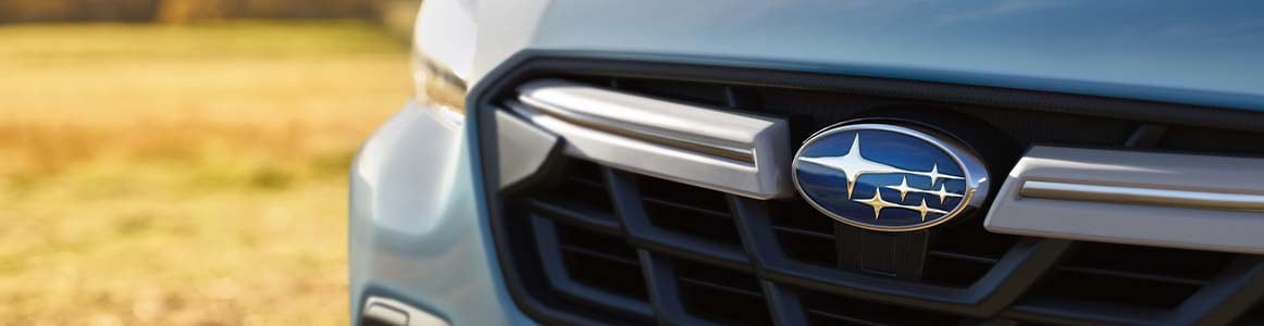 Closeup of Subaru emblem.