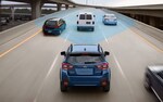 A 2020 Crosstrek driving on a freeway with the EyeSight® Driver Assist Technology sensors illustrated with blue overlay.