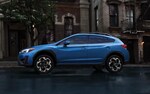 A 2021 Subaru Crosstrek driving on a rainy street.