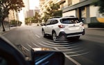 A 2021 Subaru Outback driving on a country highway.