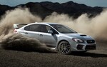 The 2021 WRX STI taking a sharp turn on a dirt road.