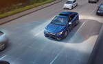 A photo illustration showing the EyeSight<sup>®</sup> Driver Assist Technology sensors on a 2022 Subaru Legacy driving down a highway. 