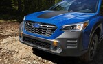 A close up of the front grill of the 2022 Outback Wilderness showcasing the LED fog lights and front tow points.